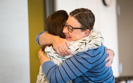 Two former caregivers hug at the UCSF Neuro-Oncology Caregiver Retreat 2018