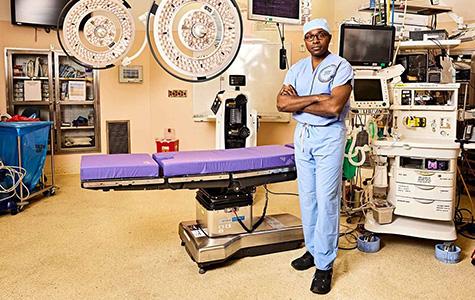UCSF neurosurgeon Shawn Hervey-Jumper, MD, standing in the OR. Photo by Gabriela Hasbun..