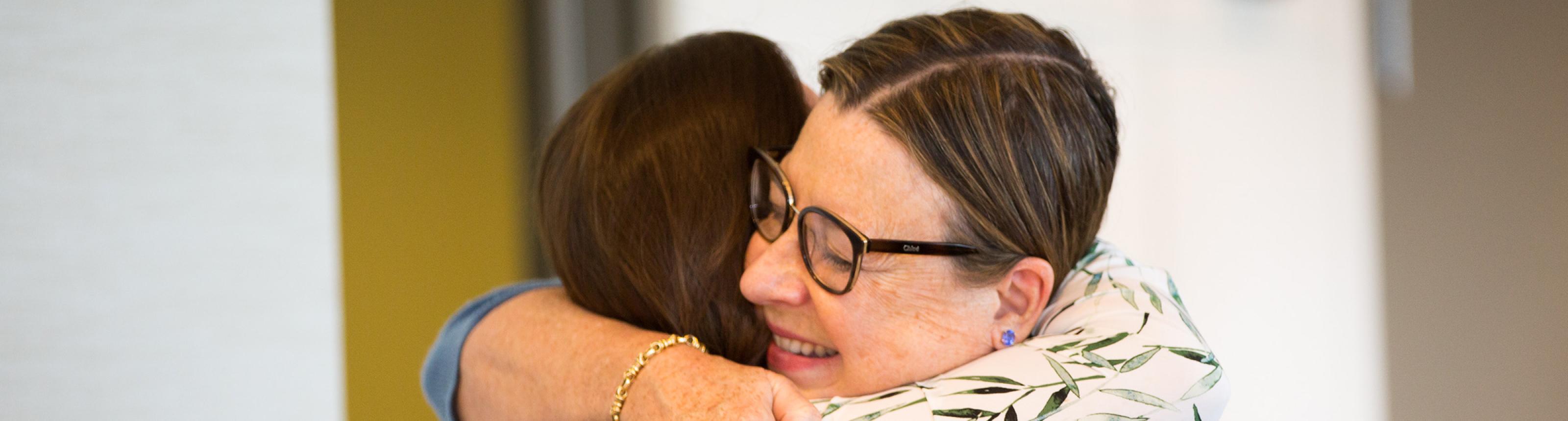 Two people hugging at the 2018 Caregiver Retreat