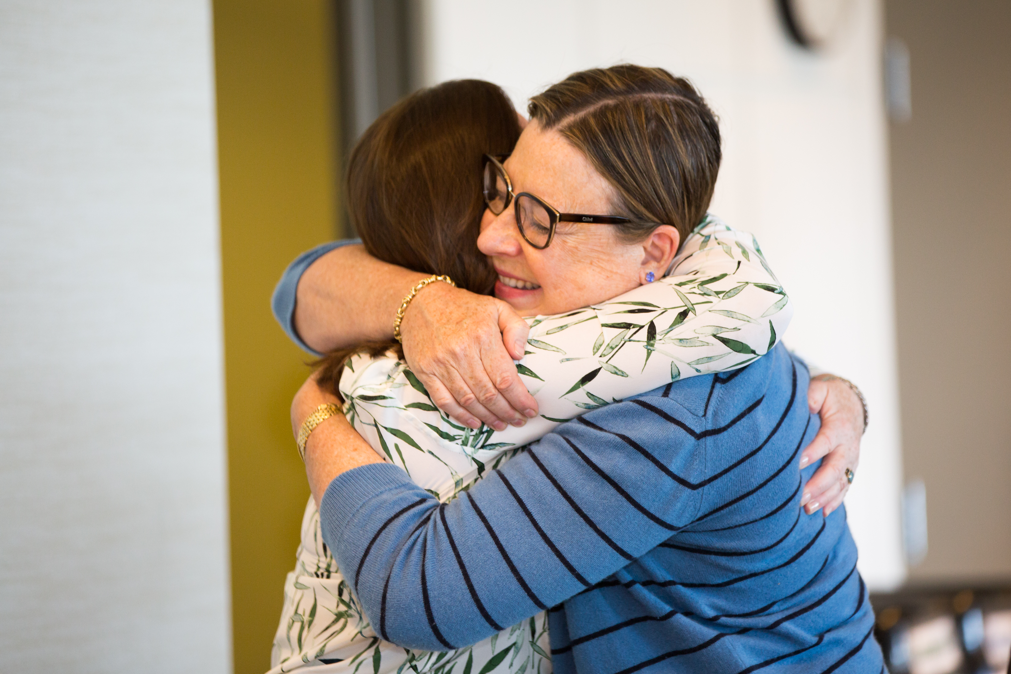 Caregivers hugging at the annual Caregiver Retreat