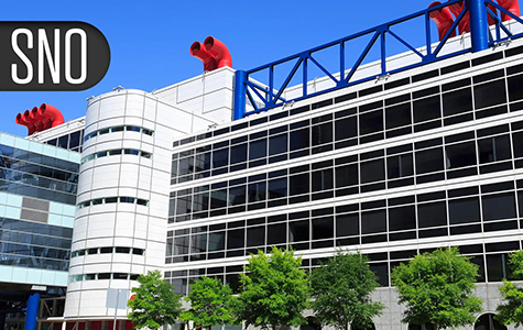 Graphic showing the letters S.N.O. over a photo of the George R. Brown Convention Center in Houston, Texas.