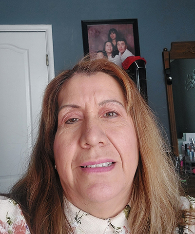 Selfie of a woman in her bedroom.