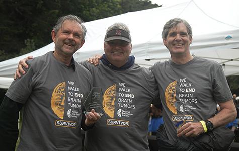 Three of the UCSF Thrivers who participated in the walk stand together holding a fundraising award.
