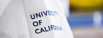 White lab coat with navy blue text that says "University of California"