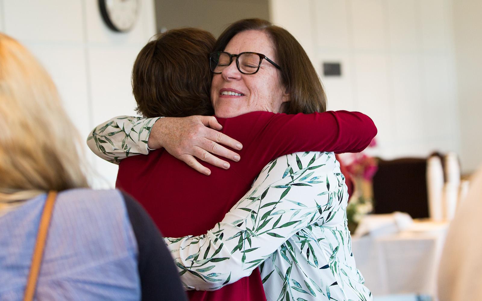 Photo showing two women hugging at the 2018 UCSF caregiver retreat