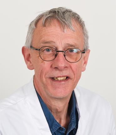 Martin van dent Bent, MD, PhD, shown wearing a lab coat